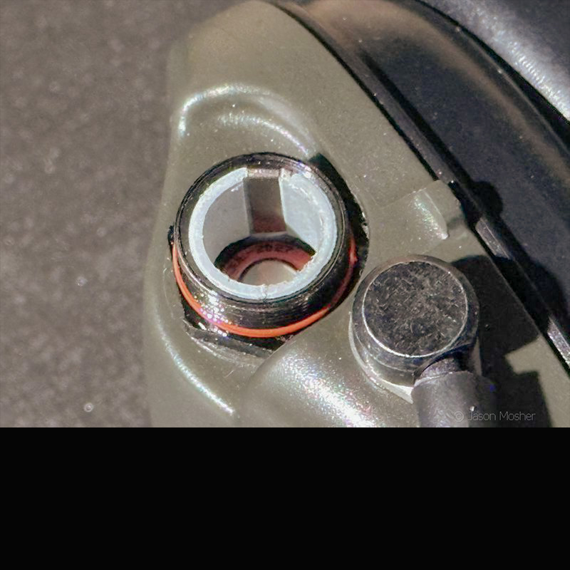 The battery compartment to electronic earmuffs. You can see the opening with a battery inside.