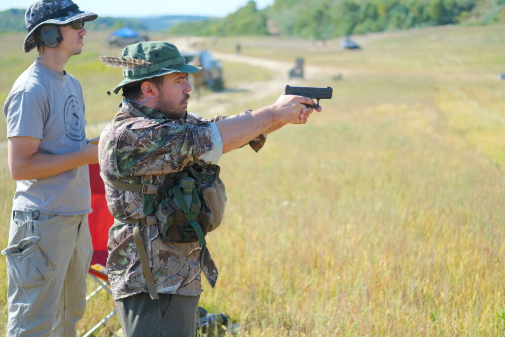 competitor firing a Glock 26 at the pistol stage of the Lightfighter Challenge