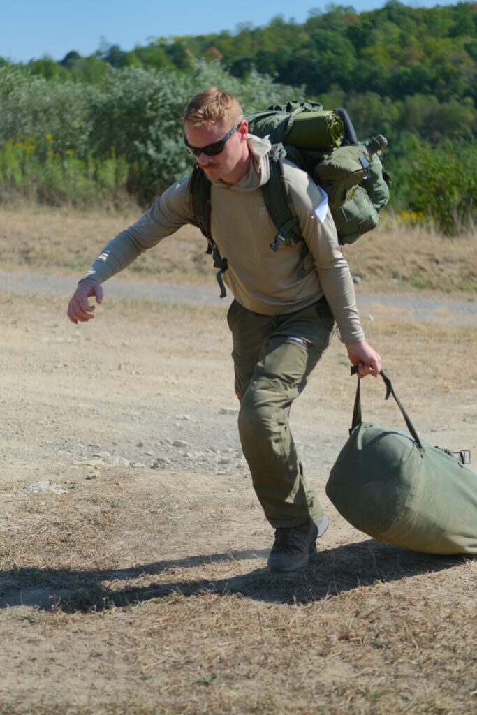 light fighter challenge competitor drags a heavy duffle bag during the hunt challenge