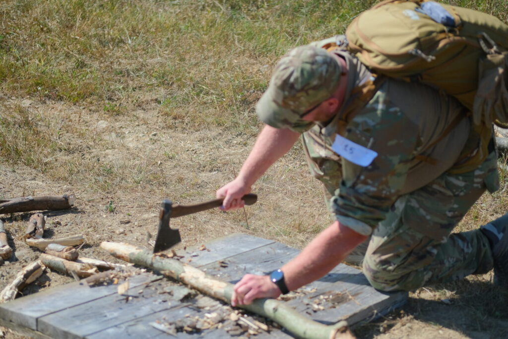 lightfighter challenge competitor uses a hatchet to chop a branch