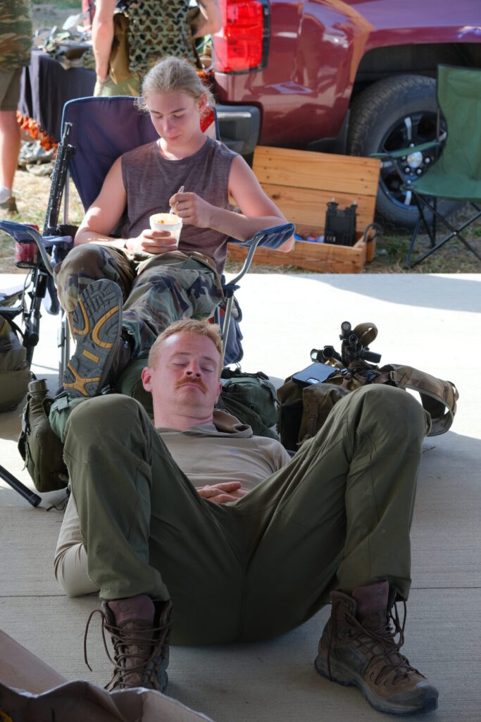 post competition Lightfighter lies down with his head on his ruck and naps