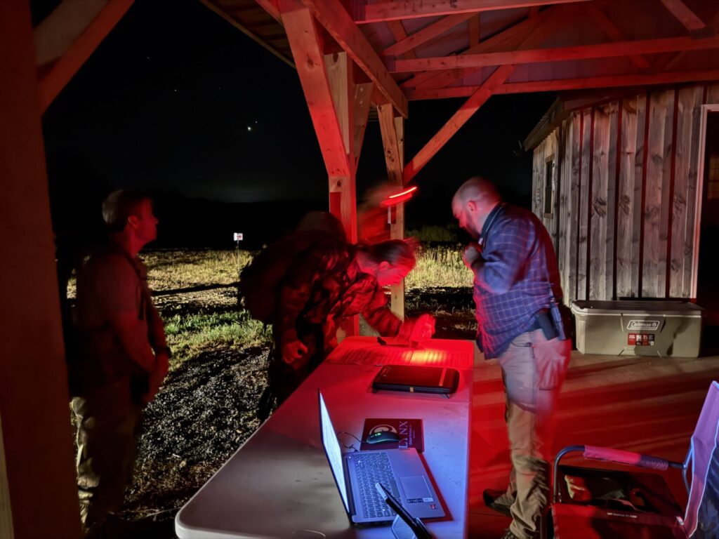 competitor checks in with volunteer in the pre-dawn morning