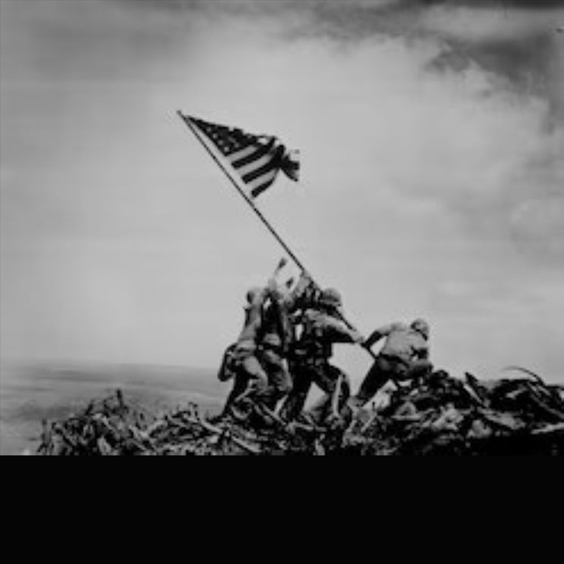 A photo of multiple marines pushing up a flag pole with the US flag on it. Iwo Jima