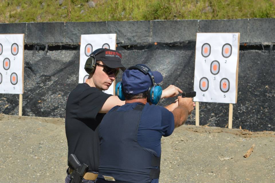 Police Handgun accuracy course student getting individual attention from instructor Ken Stretz of Stretz Tactical