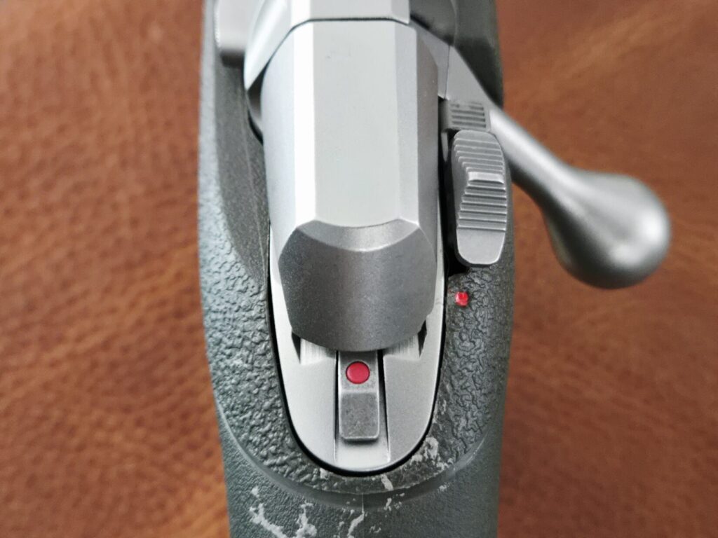 Closeup of the rear of a rifle bolt with safety off