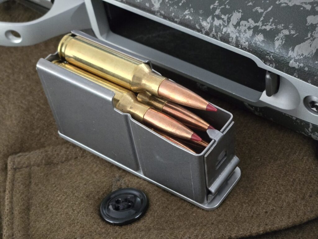Rifle ammunition in a detachable magazine on top of a wool hunting vest