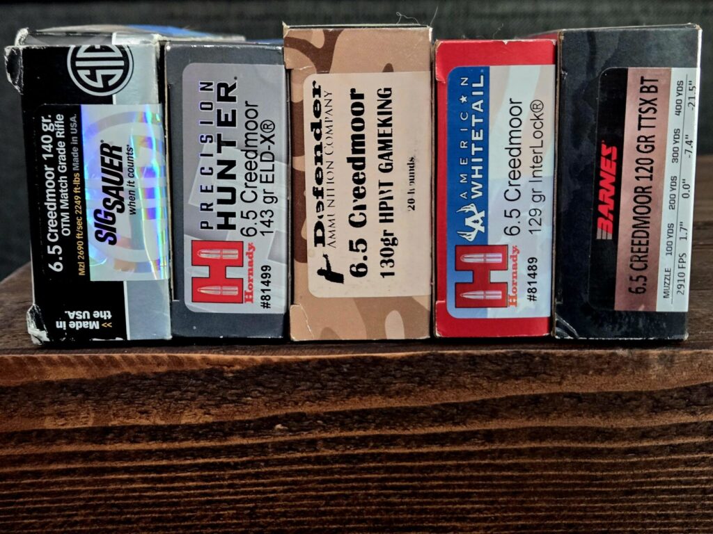 various boxes of ammunition on a wooden table