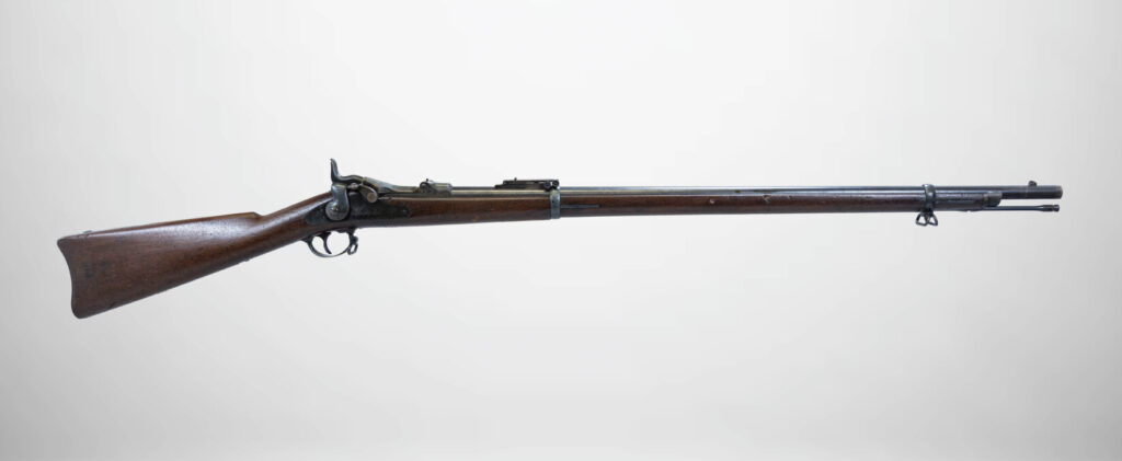 Studio shot of Springfield Model 1873, an antique, wooden Springfield Model 1873 Trapdoor rifle.