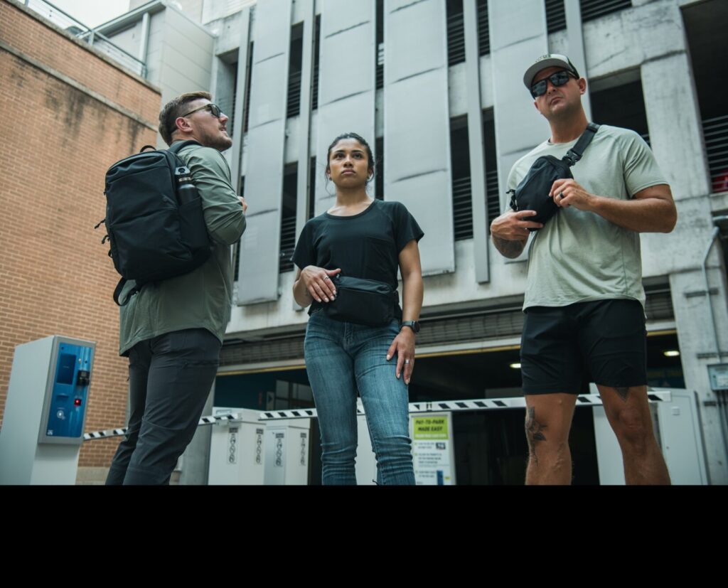 Three people wearing Vertx Everyday Fanny Pack 2.1; Everyday Fanny Pack+; and the Any Day Backpack