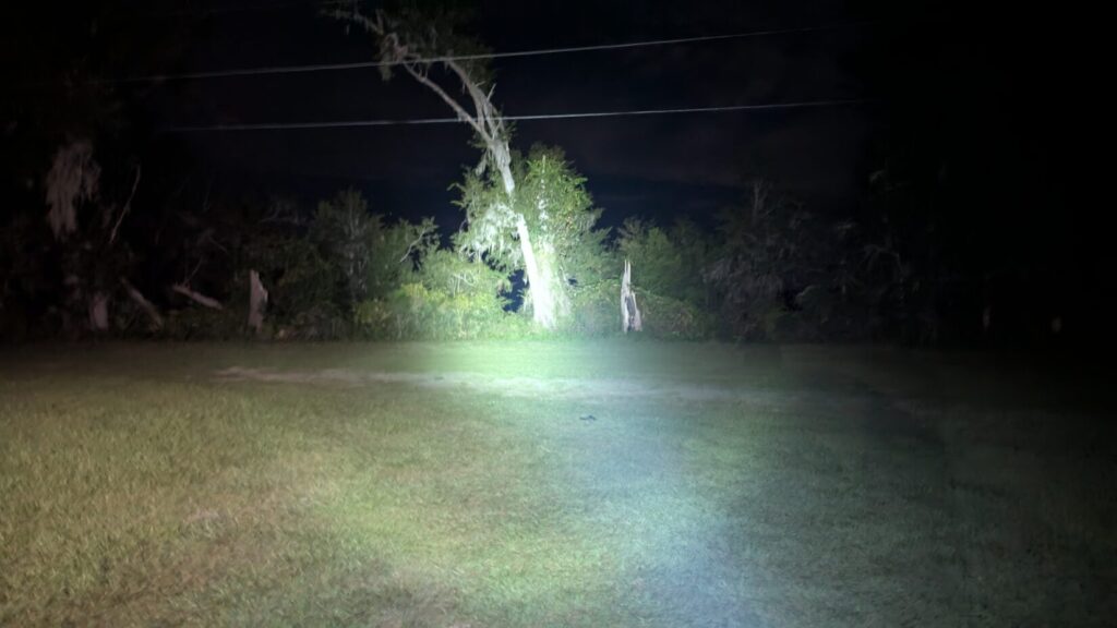 braun weaponlight shining outdoors at night