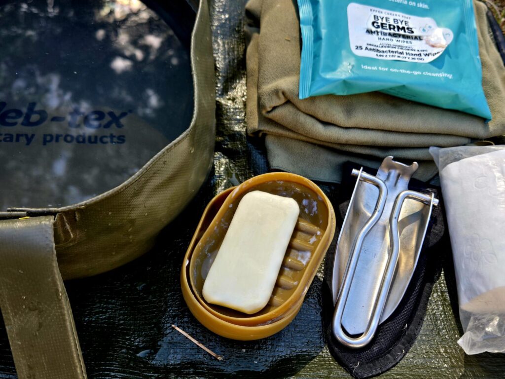 Camp hygiene products. Folding shovel, soap, bucket, camp towel.