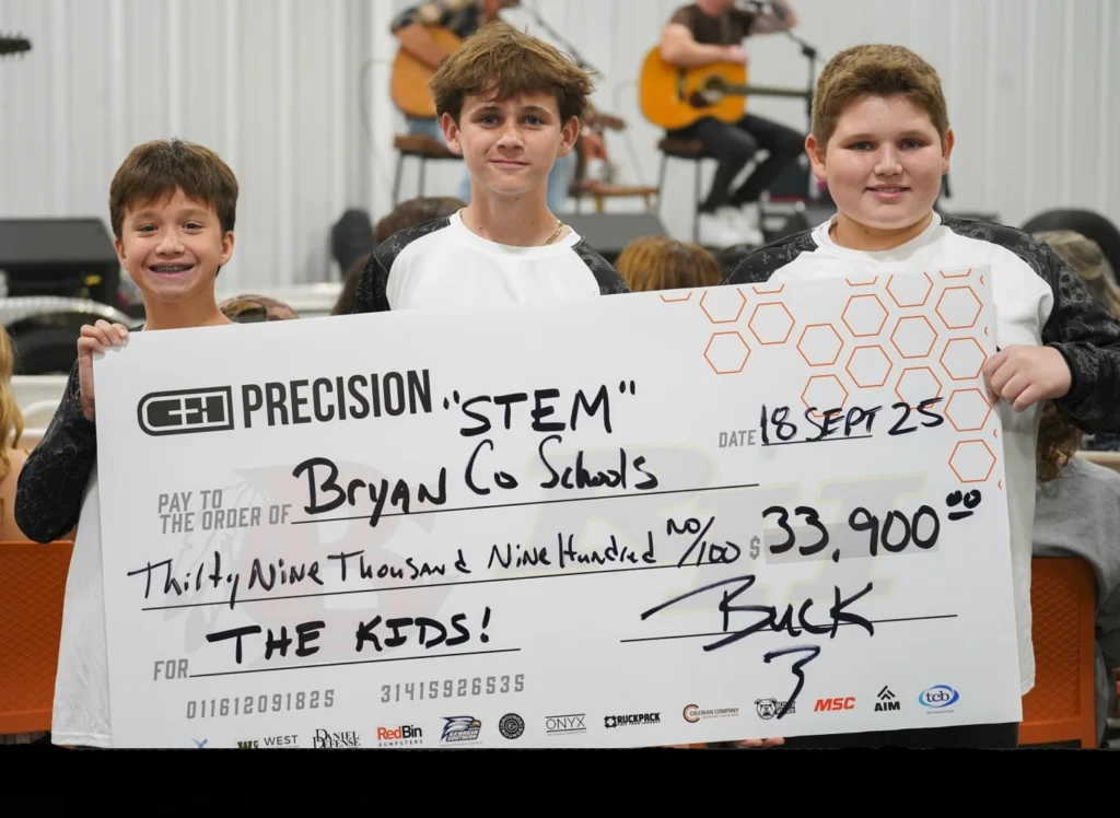 Students holding a large check from the C&H Precision STEM fundraiser