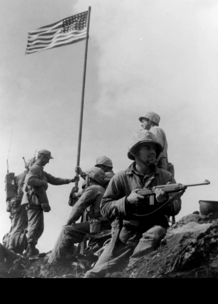 Marines raising the first American flag on Iwo Jima's Mount Suribachi
