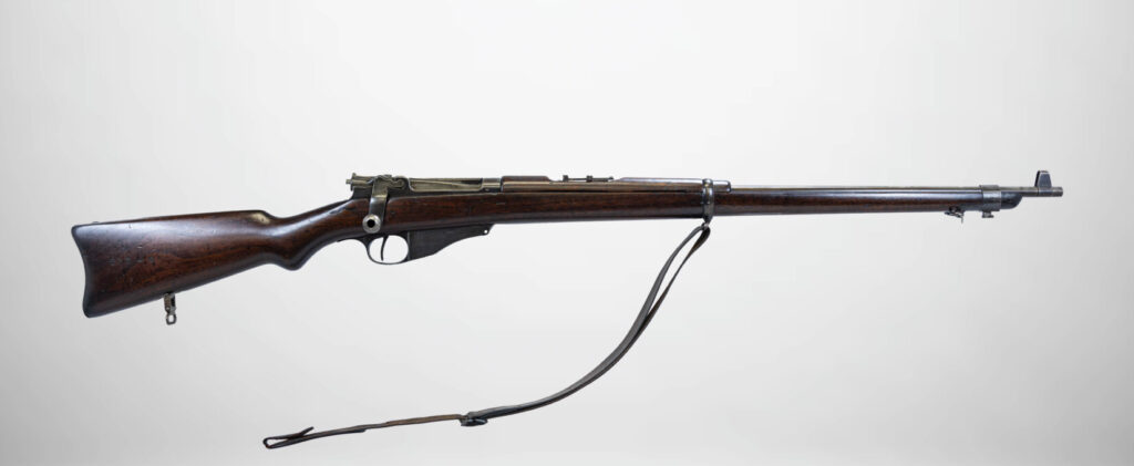Studio shot of Model 1895 Winchester-Lee straight pull rifle, a wooden-stocked Lee-Navy bolt-action rifle with a sling.