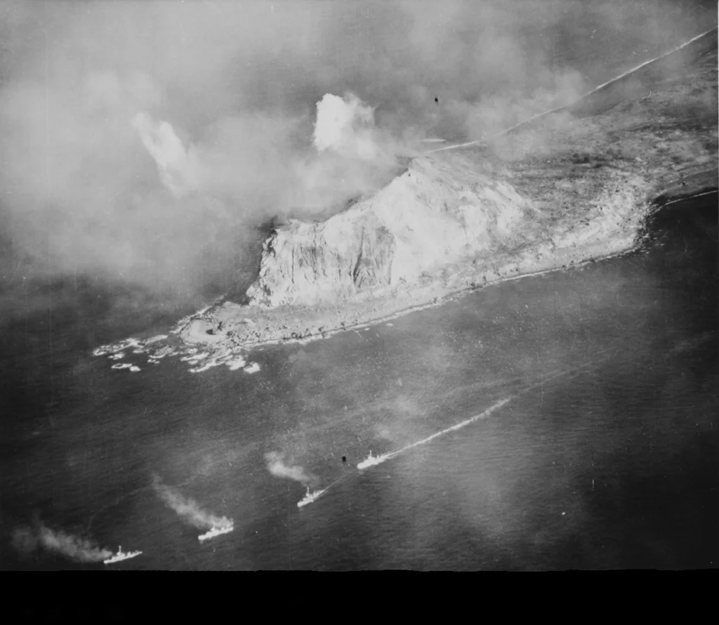 Aerial photo of naval and air strikes against Iwo Jima's Mount Suribachi.