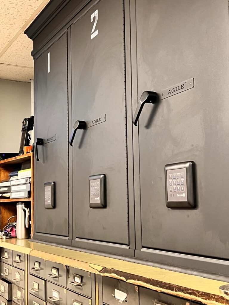 Unsecured gun locker on opposite side of desk from where prisoners are held