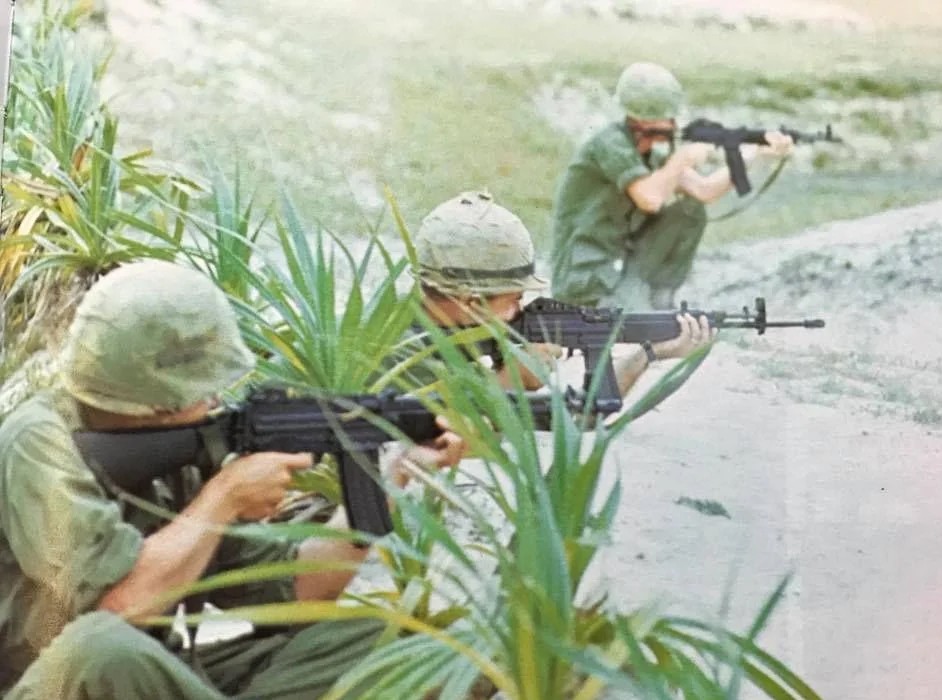 three soldiers shooting stoner 63 rifles