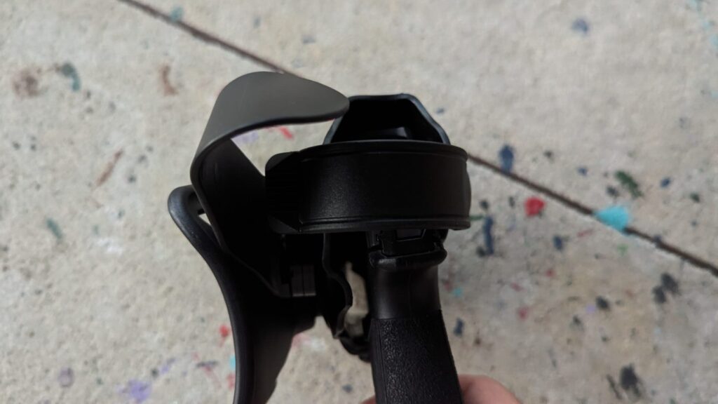 Close-up of the retention area of a black holster with a handgun inside.