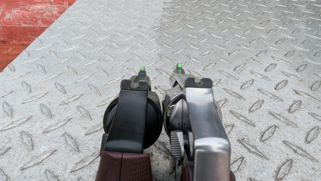 Rear view showing the green fiber optic front sights and rear sights of the two revolvers in alignment.