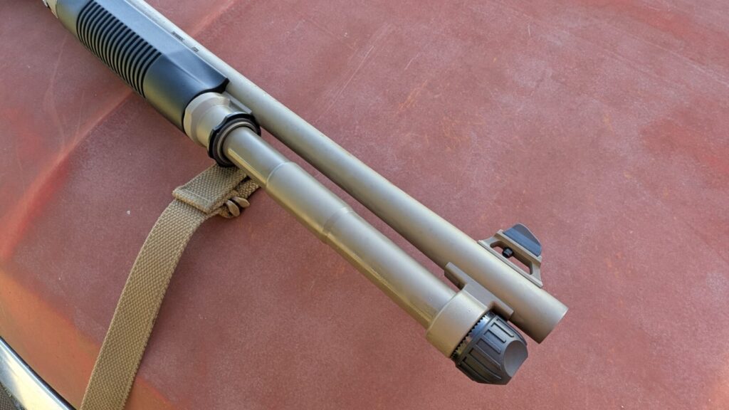 Close-up of the Benelli M4's barrel and magazine tube assembly with front sight.