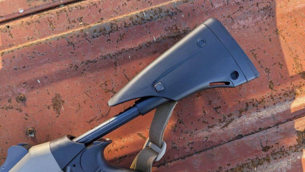 Close-up of the Benelli M4's fixed pistol grip stock.