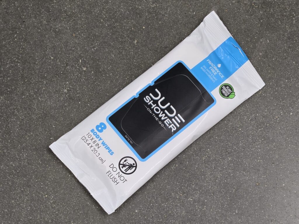 A package of body wipes against a concrete floor