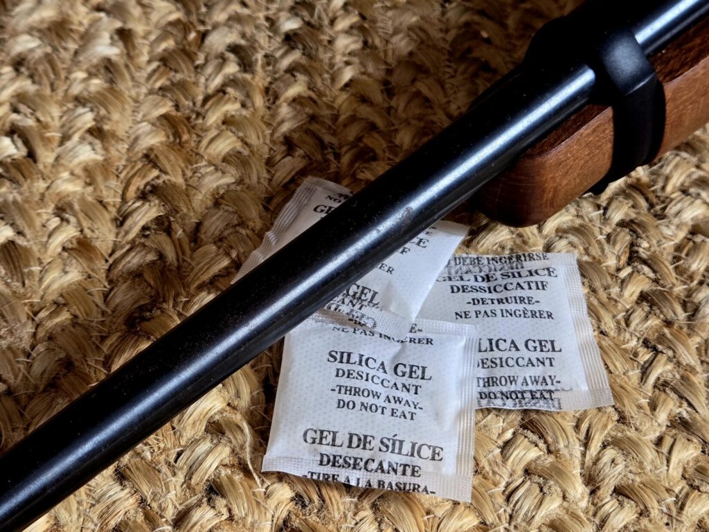 A rifle barrel with minor surface rust and silica desiccant packets