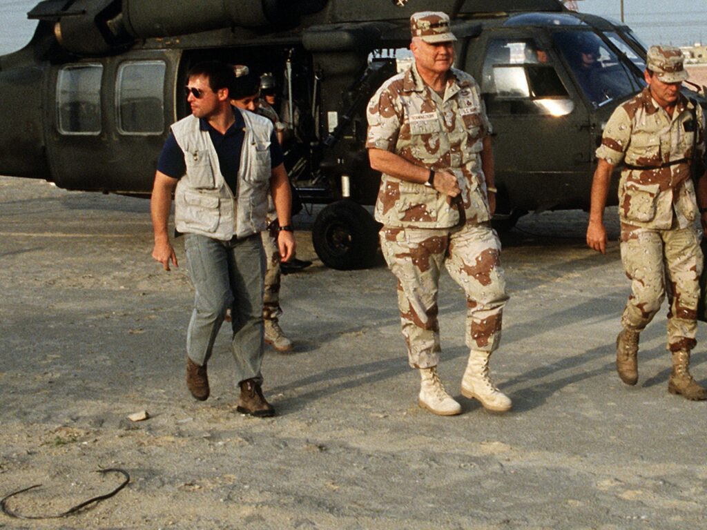 Delta Force bodyguard in civilian clothing wearing CARGO vest while providing close protection to General Norman Schwarzkopf during the Gulf War, 1991. (U.S. Army photo by Staff Sergeant Dean W. Wagner)