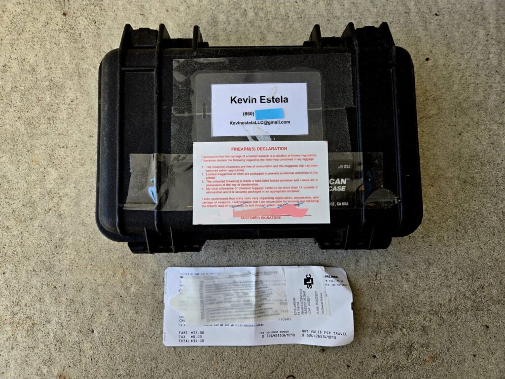 A small black pelican case with airline tags around it