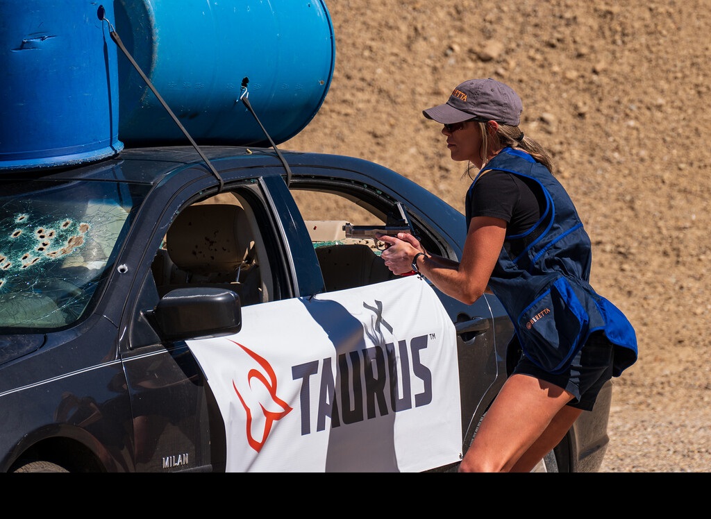 female IDPA shooterwearing a vest
