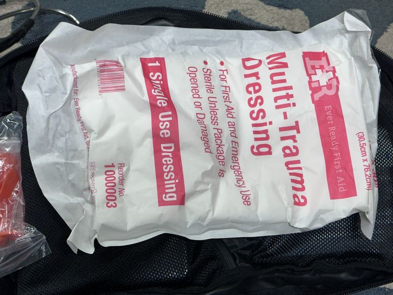 A large white package containing a trauma dressing pad. 