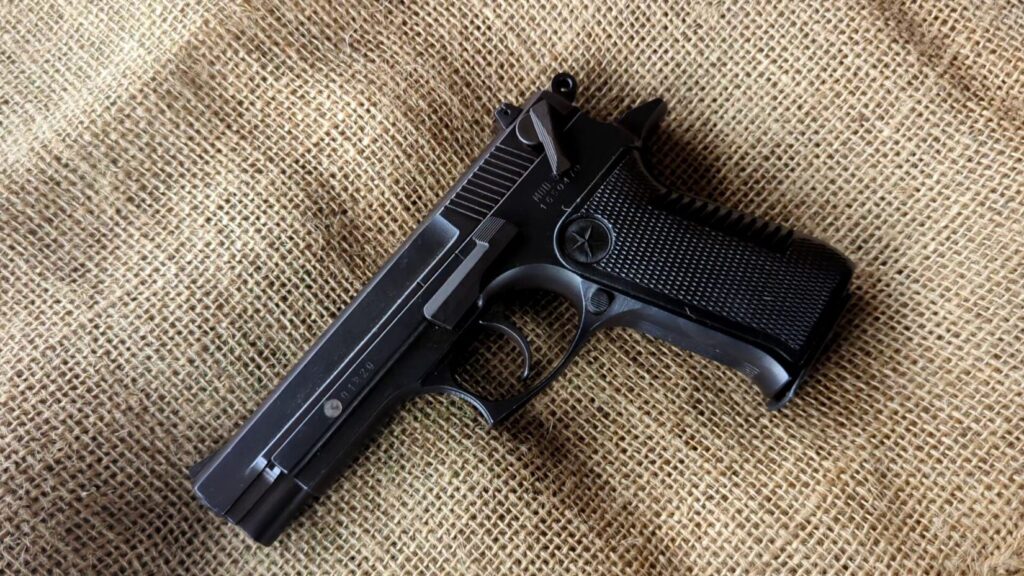 Star 30M pistol on a piece of burlap or canvas fabric.