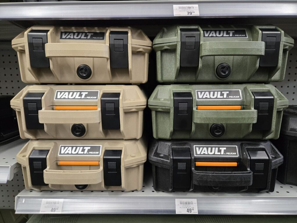 Tan, green, and black Pelican hard cases for sale at a store