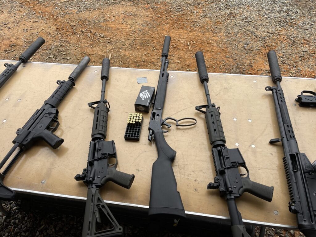 suppressed rifles on a range table at CanCon 2025