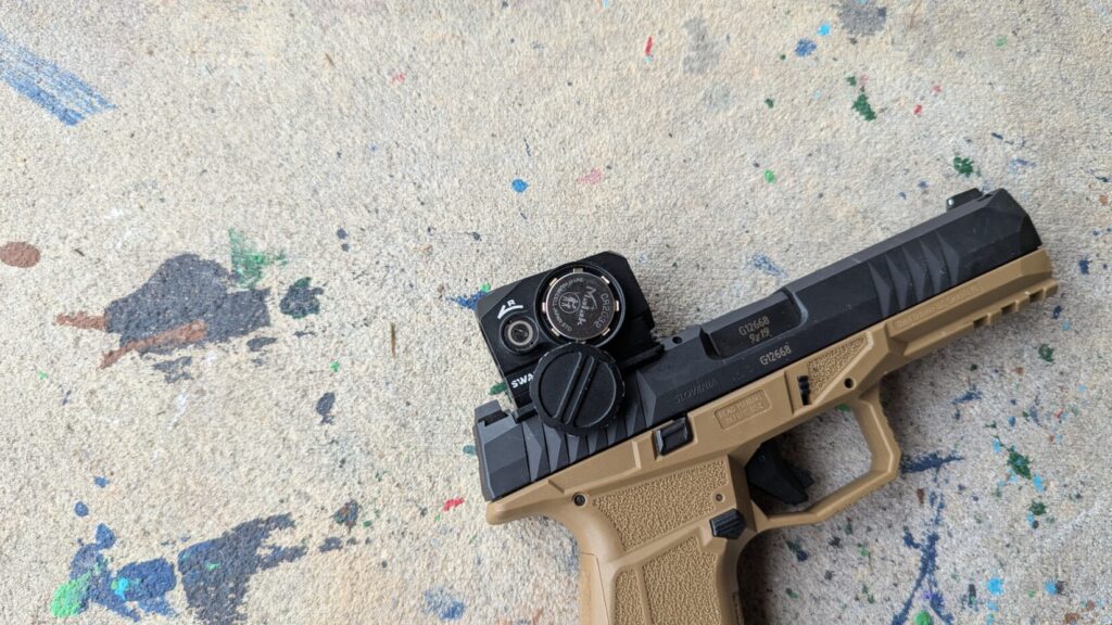 Tan and black pistol with a Swampfox mounted