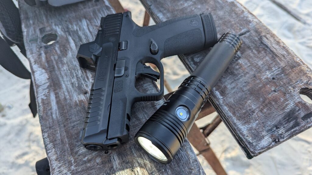 Shield X and handheld held light on wooden bench