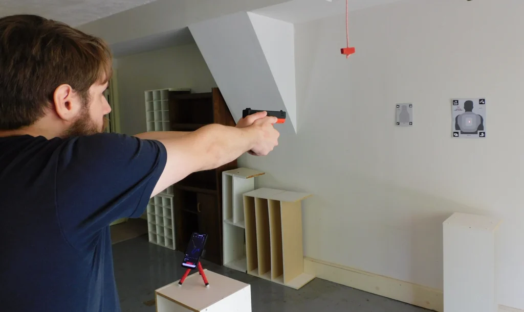 Man dry fire training indoors with a Mantis Titan x laser training pistol