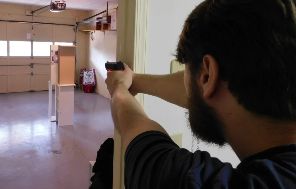 Man firing a hostage rescue drill with the Mantis Titan X laser training pistol