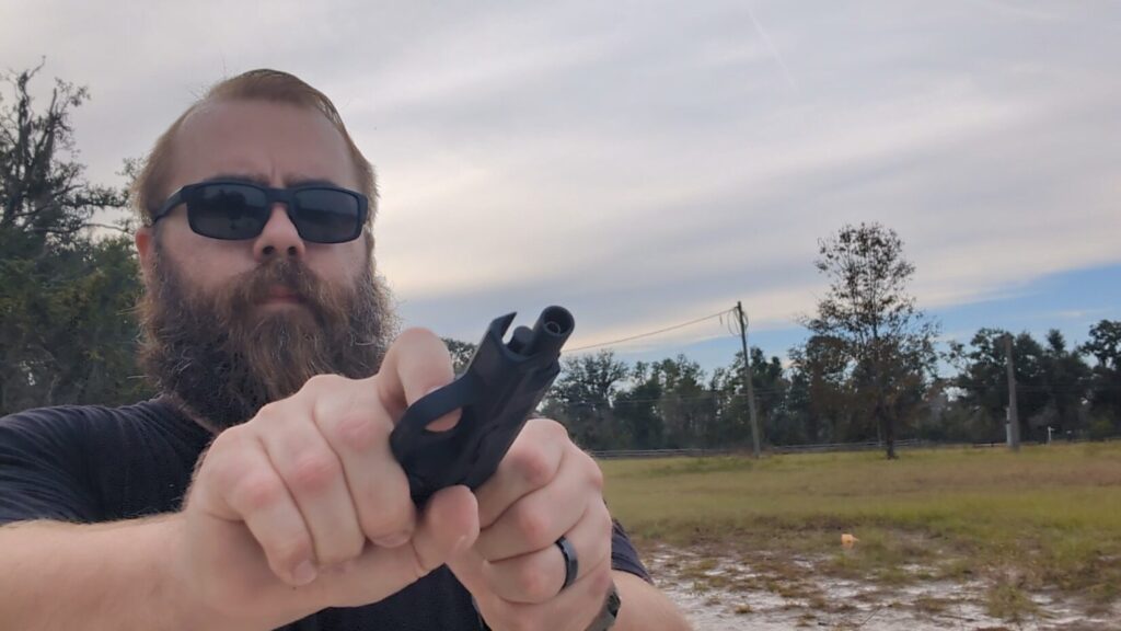Man working slide of SIG P365 BB pistol 