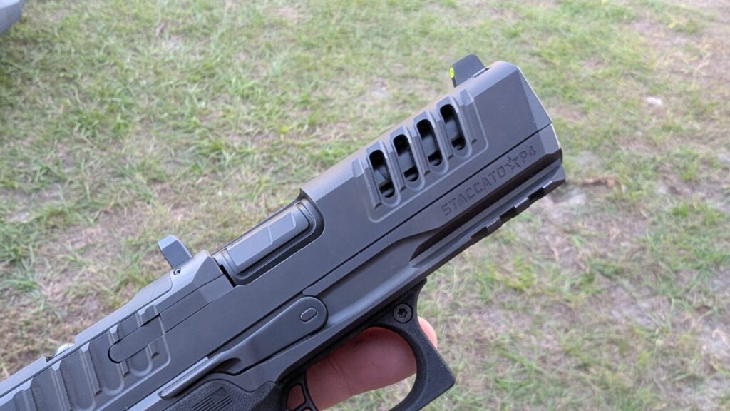 Close-up of a hand holding the muzzle end of a Staccato HD P4 slide