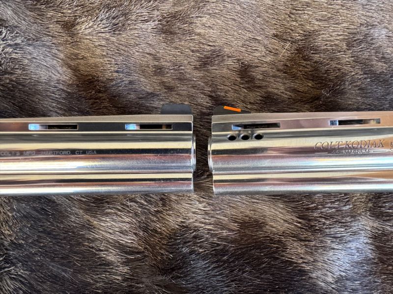 Colt provides the orange insert front sight (right) and the replacement is from Harrison Design.