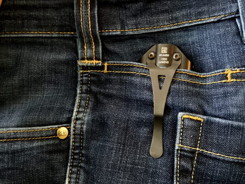 A flashlight clipped to jeans pocket