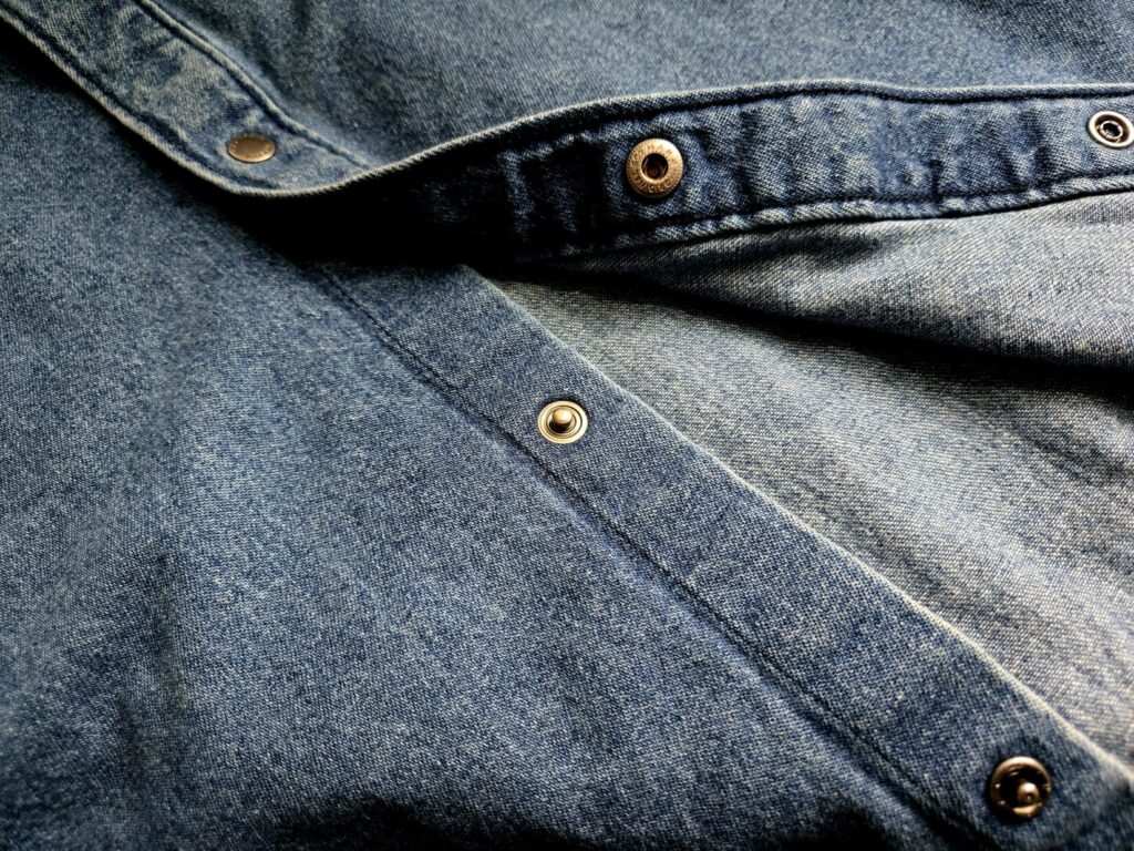 Buttons on a blue denim shirt