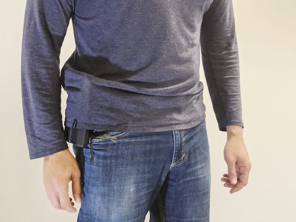 A man in a pair of jeans and a blue long sleeve shirt