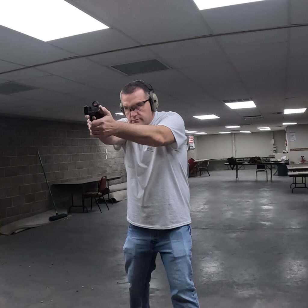 man shooting SAR9sc in indoor range