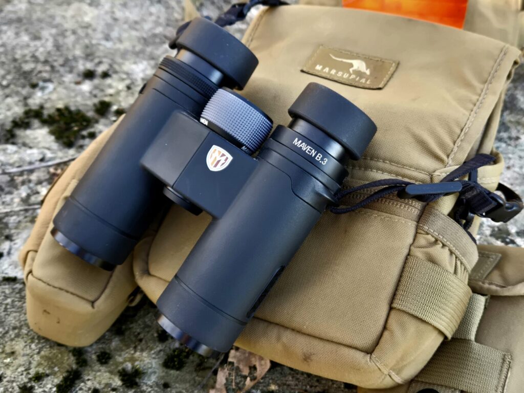 Hunting gear laid out with a cup of coffee, a reminder to balance caffeine with water in the field