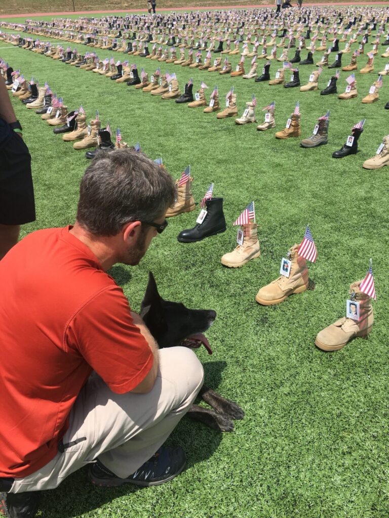 Rick Hogg and SOF K9 Duco at the Ft Bragg's boot display during Memorial Day