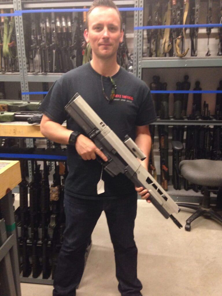 Hollywood Armorer Ken Stretz holds a real semi-automatic rifle housed inside an outer shell designed by an art department to make a blank firing gun look space age and futuristic