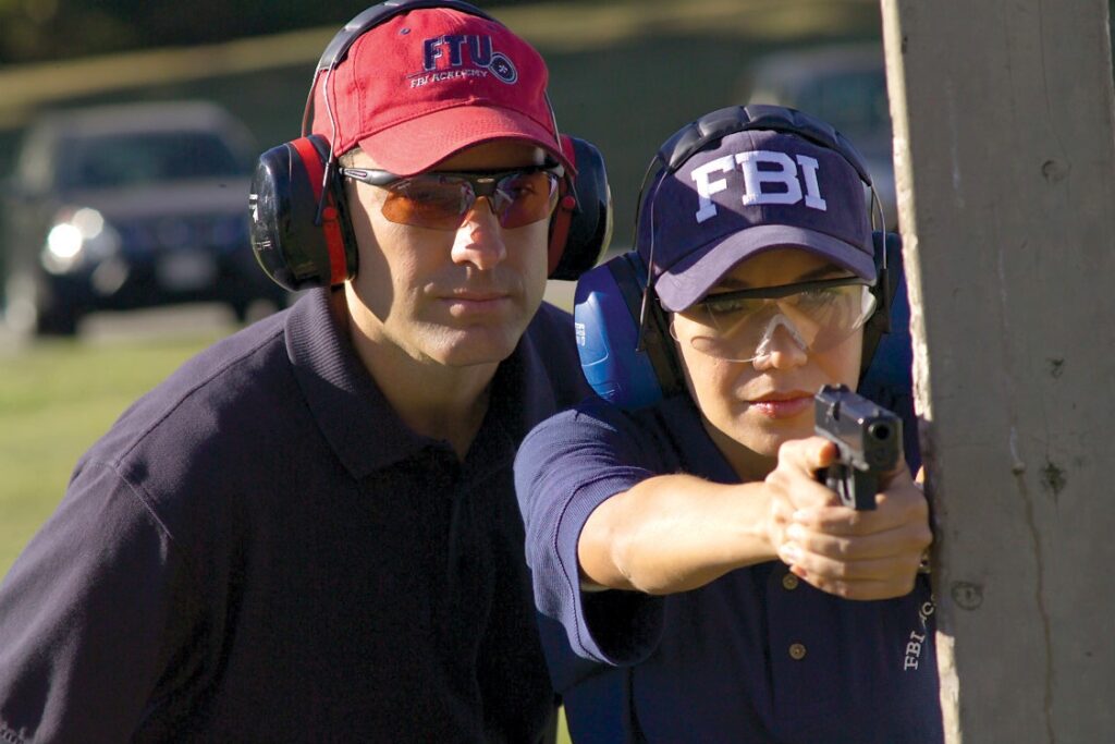 New agent practices firing a 9mm weapon outdoors during firearms training at a firing range at Quantico, Virginia. (Image: FBI)