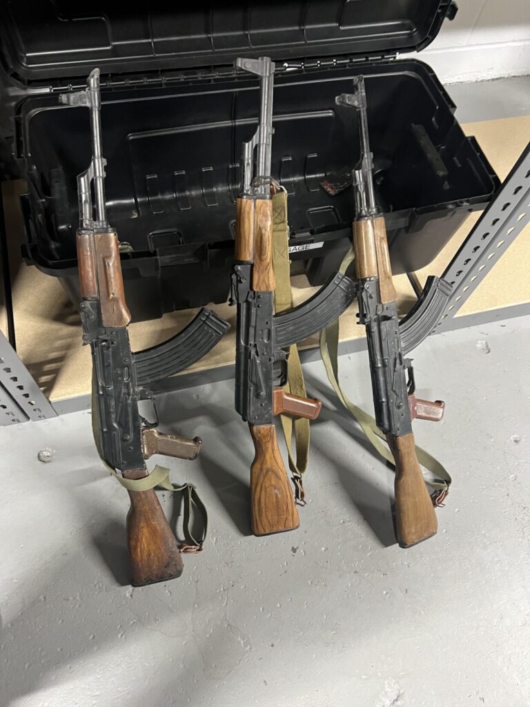 Three rubber movie prop AK47s painted to look like wood and metal with slings attached